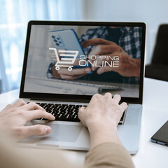 Online shopping concept. Man hands using laptop and smartphone to Internet purchase.