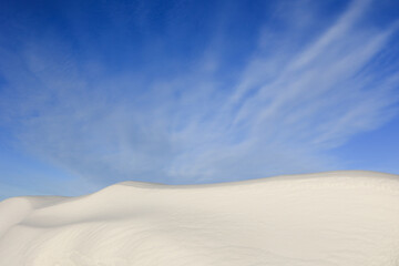 Large snowdrift with blue sky background.