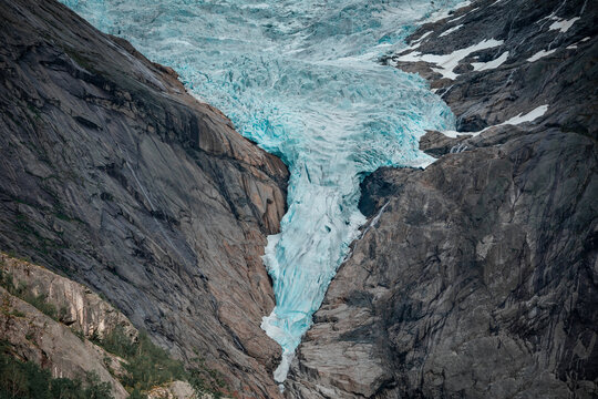 Briksdalsbreen glacier in the mountains of Jostedalsbreen national park in Norway, blue ice melting in summer