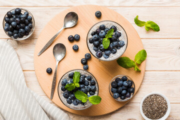 Healthy breakfast or morning with chia seeds vanilla pudding and blueberry berries on table background, vegetarian food, diet and health concept. Chia pudding with coconut milk and blueberry