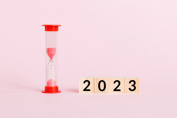 New Year 2023 sand timer. Resolution, time, plan, goal, motivation, reboot, countdown and New Year holiday concepts. Hourglass with number 2023