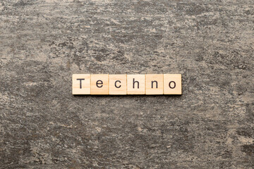 techno word written on wood block. techno text on table, concept