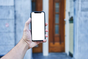 Man holding smartphone showing white blank screen at street