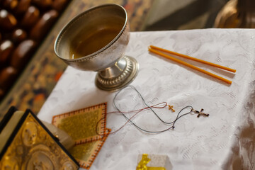 Throne, Holy Meal, Altar, antimension, gospel, altar cross, tabernacle and lampada and two crosses for the baptism of a child in an Orthodox church Defocused