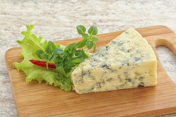 Blue cheese piece over board