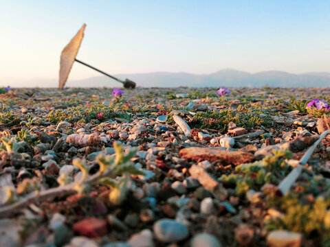 Forgotten fallen umbrella from summer in a calm winter day in Digeliotika beach in Aeghion, Greece. February 2021