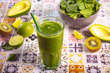 Healthy raw vegan green smoothie with spinach, kiwi, avocado and lime