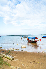 Naklejka premium The scenery of the estuary with the bridge crossing is very beautiful, the sky is clear and the small boats are ready to go fishing