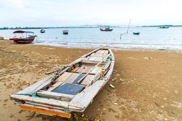 Fototapeta premium The scenery of the estuary with the bridge crossing is very beautiful, the sky is clear and the small boats are ready to go fishing
