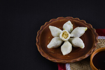 makar sangkranti or poush sangkranti celebration with puli pithe or bengali rice flour dumplings...