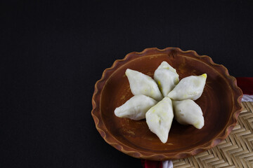 makar sangkranti or poush sangkranti celebration with puli pithe or bengali rice flour dumplings...