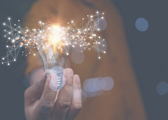 Businessman holding lightbulb on hand with technology network internet digital. Creativity...