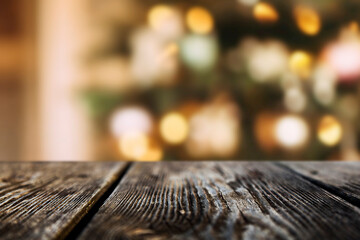 Wooden background with Christmas lights and bokeh in the interior. Copy space