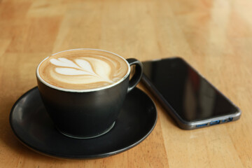 a cup of late coffee with flower shape design on top at cafe 