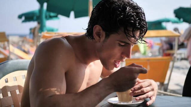 Young man by the sea at a beach bar