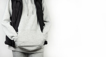 Girl in sportswear and a black jacket on a white background. Youth clothes.