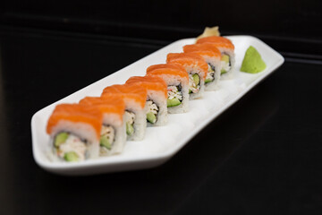 Sushi on a stone plate with black background