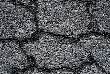 Close-up of gray asphalt with crack texture background. Copy space