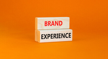 Brand experience symbol. Concept words Brand experience on wooden blocks. Beautiful orange table orange background. Business branding and brand experience concept. Copy space.