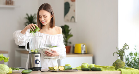 Young woman preparing healthy green smoothie in kitchen