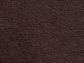 Genuine luxury dark brown leather texture sample. Background with copy space. Faux eco leather. Textured backdrop effect for design, upholstered furniture, clothing. Pattern with place for text.