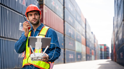 A foreman or worker pilots a drone at a container port used a remote controller for checking container.