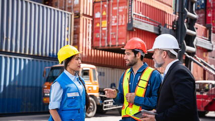 Businessman,  Engineer or foreman talking and checking inventory or task details at container yard warehouse., Logistics concept inside the shipping, import, and export industries..