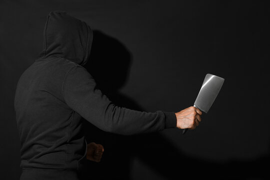 Maniac with cleaver on black background