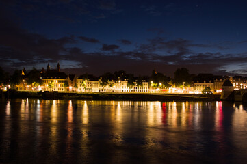 Fototapeta na wymiar Cityscape of the center of Maastricht in twilight in the Netherlands with in the foreground the river Meuse