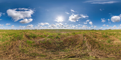 full seamless 360 hdri panorama view among farming field with sun and clouds in equirectangular...