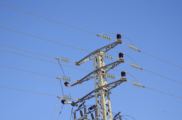 High-voltage poles, street power lines. Close-up. Concept: energy savings, solar panels, utility bills.