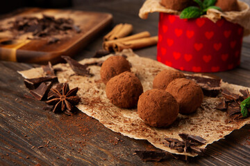 Homemade Chocolate Truffles with Cocoa Powder on Brown Wooden Table.