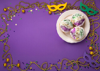 Mardi Gras King Cake Sufganiyot Donuts, Carnival Masks on Purple Background.
