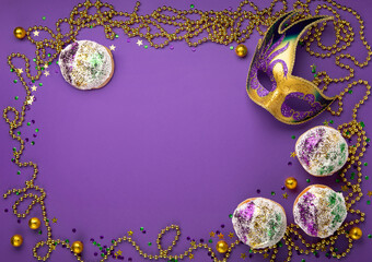 Mardi Gras King Cake sufganiyot donuts, masquerade festival carnival mask, gold beads and golden,...