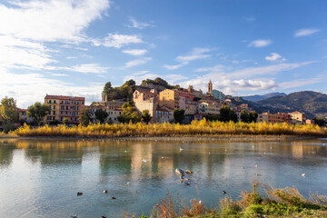 Old Residential Homes near river and sea in Ventimiglia, Italy. Sunny Fall Season.