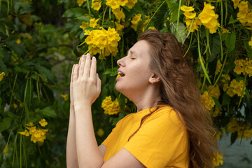 Portrait of beautiful young allergic woman is suffering from pollen allergy or cold on natural...