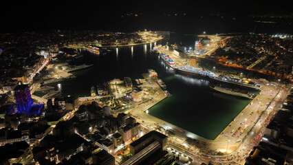 Aerial drone night shot of illuminated tower of Piraeus and port of Piraeus during Christmas...