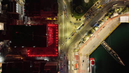 Aerial drone night shot of illuminated tower and port of Piraeus during New Year's eve...