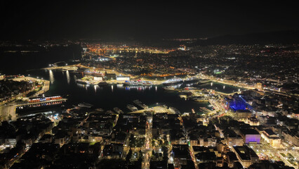 Aerial drone night shot of illuminated tower and port of Piraeus during New Year's eve celebrations, Attica, Greece