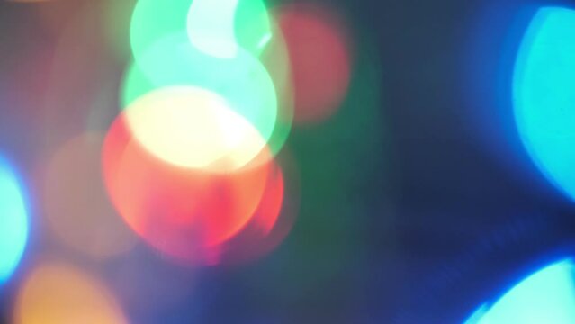 Night festive glare. Bokeh glow overlay. Defocused neon red blue color shiny flecks motion on dark black abstract background.