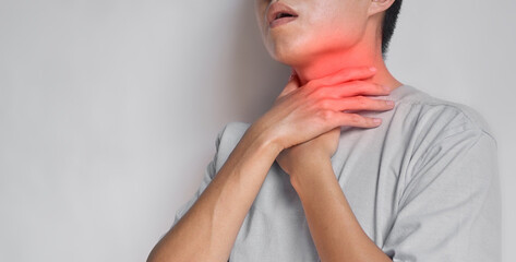 Tightness at the neck of Asian, Myanmar man. Concept of sore throat, pharyngitis, laryngitis,...