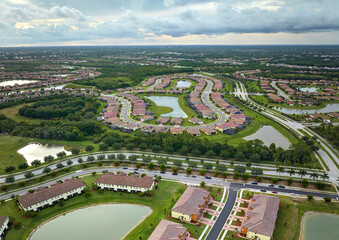 Aerial view of tightly packed homes in Florida closed living clubs. Family houses as example of real estate development in american suburbs