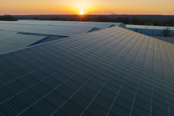 Blue photovoltaic solar panels mounted on building roof for producing clean ecological electricity...