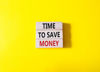 Time to save money symbol. Wooden blocks with words Time to save money. Beautiful yellow background. Business and Time to save money concept. Copy space.