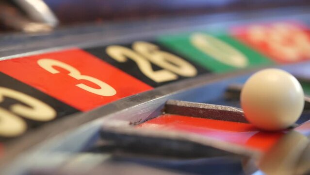 Ball on wooden french roulette table in casino. Wheel spinning, turning or rotating. Odd and even numbers, black, red and zero sectors. Bets in game of chance. Money playing, gambling or risky betting
