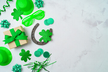 St Patrick's day holiday background with lucky charms, shamrock and gift box. Top view, flat lay