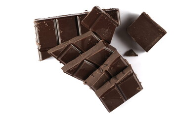 Chopped chocolate pile, piece isolated on white, top view