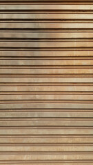 Textured pattern of rusty metal gate, brown in color, with horizontal lines.