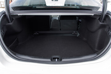 Modern sedan car open trunk. Huge, clean and empty car trunk in interior of modern car.