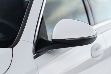 Close up front view of car side mirror. Front rear view mirror on the car window. White car...